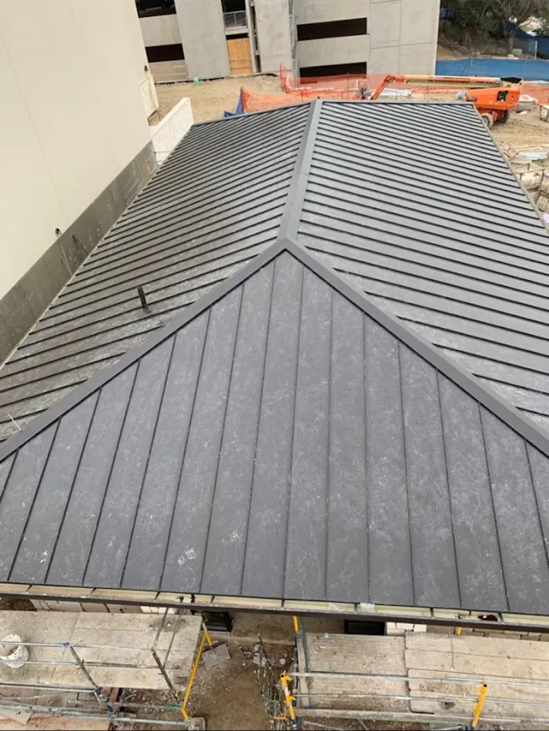 Commercial metal roof construction with crane equipment in Pittstown